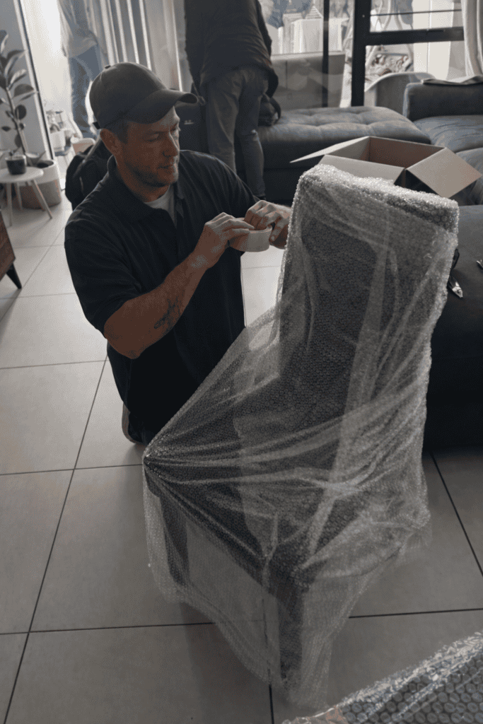 Fragile furniture being carefully wrapped for moving by professional movers in South Africa.